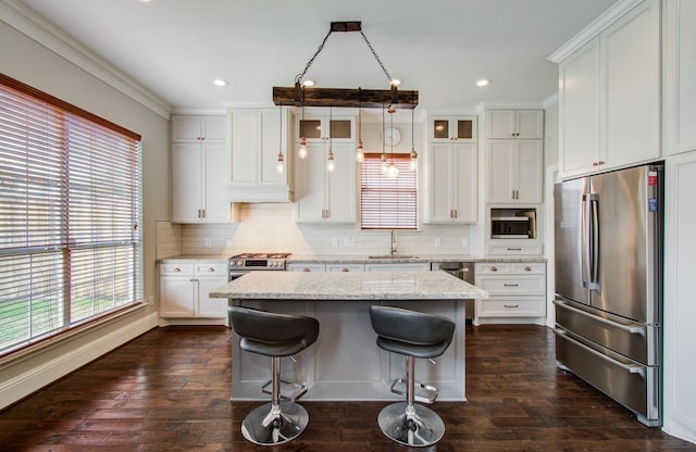 4303 Jonathan St, Bellaire, TX 77401 - kitchen with appliances with stainless steel finishes, a sink, a kitchen island, glass insert cabinets, and decorative backsplash