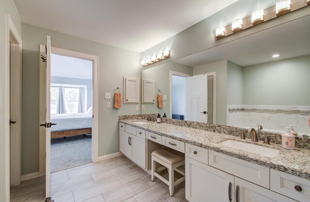 4303 Jonathan St, Bellaire, TX 77401 - ensuite bathroom with double vanity and baseboards