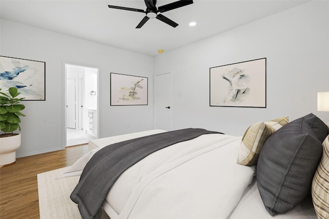 20419 Thunder Ridge Ln, Katy, TX 77449 - bedroom featuring wood finished floors, recessed lighting, ceiling fan, ensuite bath, and baseboards