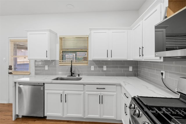 20419 Thunder Ridge Ln, Katy, TX 77449 - kitchen with appliances with stainless steel finishes, a sink, white cabinetry, and healthy amount of natural light