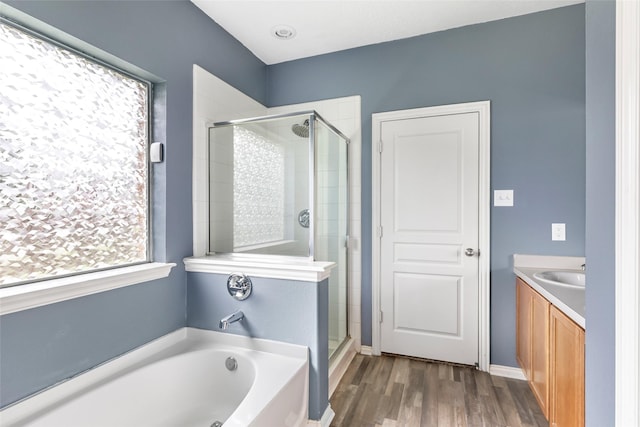 703 Windlass Way, Crosby, TX 77532 - full bathroom featuring a shower stall, a garden tub, wood finished floors, and vanity