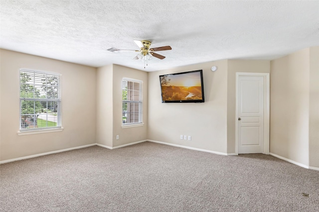703 Windlass Way, Crosby, TX 77532 - carpeted empty room with healthy amount of natural light, baseboards, ceiling fan, and a textured ceiling