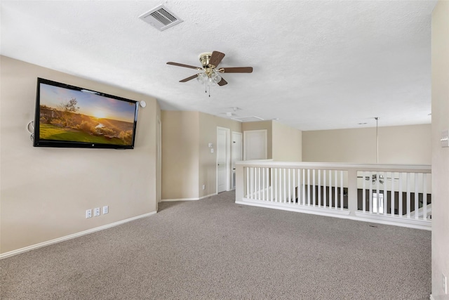 703 Windlass Way, Crosby, TX 77532 - empty room featuring ceiling fan, carpet flooring, baseboards, attic access, and a textured ceiling