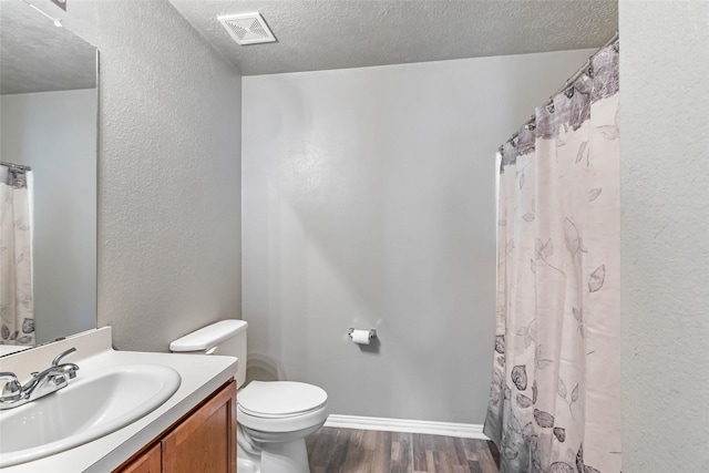 703 Windlass Way, Crosby, TX 77532 - full bathroom with wood finished floors, vanity, toilet, a textured ceiling, and a textured wall