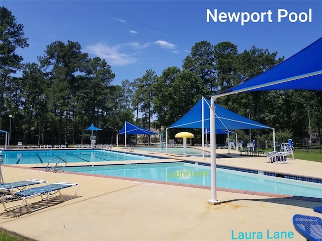 703 Windlass Way, Crosby, TX 77532 - community pool featuring a patio area and view of wooded area