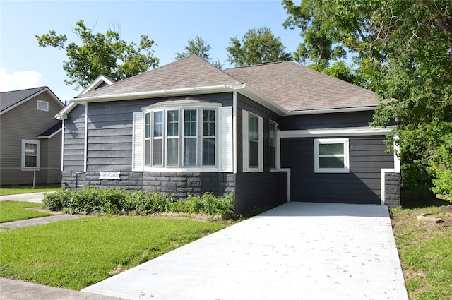 405 W Jack St, Baytown, TX 77520 - view of front of house with roof with shingles, a front lawn, and stone siding