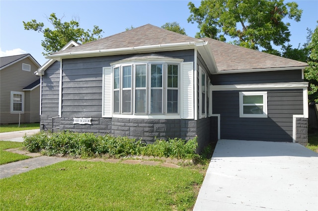 405 W Jack St, Baytown, TX 77520 - view of front facade featuring a shingled roof, stone siding, and a front yard