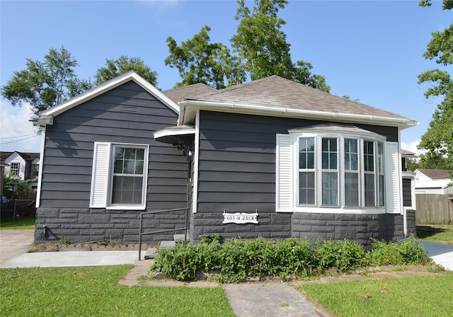 405 W Jack St, Baytown, TX 77520 - view of front facade featuring stone siding and a shingled roof