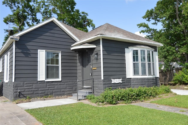 405 W Jack St, Baytown, TX 77520 - view of front of house featuring stone siding and a shingled roof