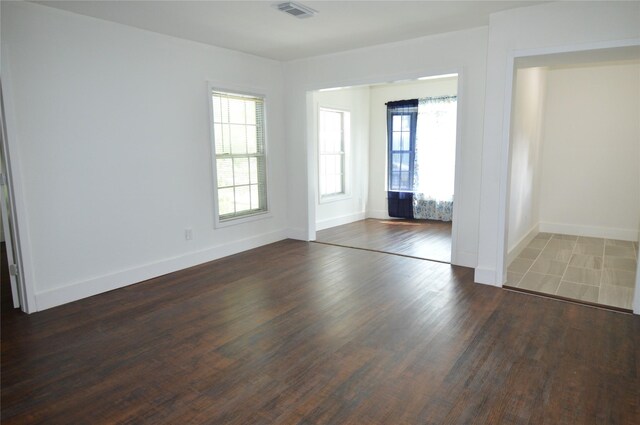 405 W Jack St, Baytown, TX 77520 - spare room featuring healthy amount of natural light, wood finished floors, and baseboards