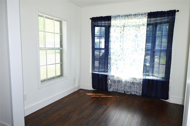 405 W Jack St, Baytown, TX 77520 - empty room with dark wood finished floors and baseboards