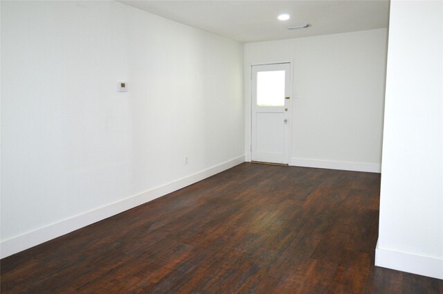 405 W Jack St, Baytown, TX 77520 - unfurnished room with dark wood finished floors, baseboards, and recessed lighting