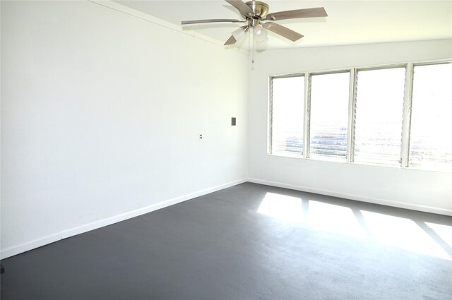 405 W Jack St, Baytown, TX 77520 - spare room with finished concrete flooring, ceiling fan, and baseboards