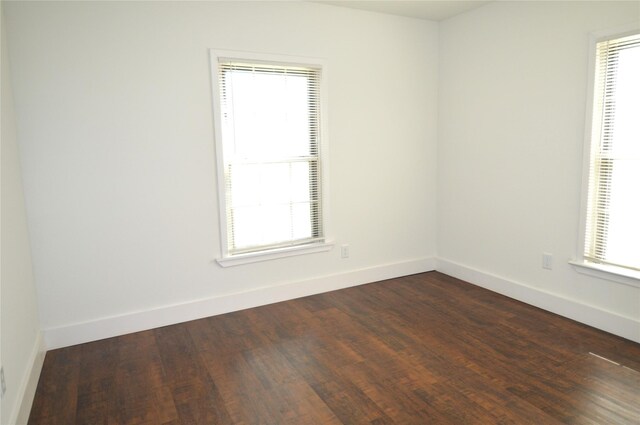405 W Jack St, Baytown, TX 77520 - empty room with plenty of natural light, baseboards, and dark wood-style floors