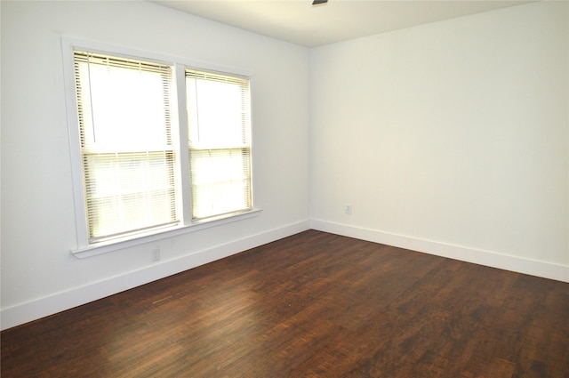 405 W Jack St, Baytown, TX 77520 - spare room with baseboards, dark wood-style flooring, and ceiling fan