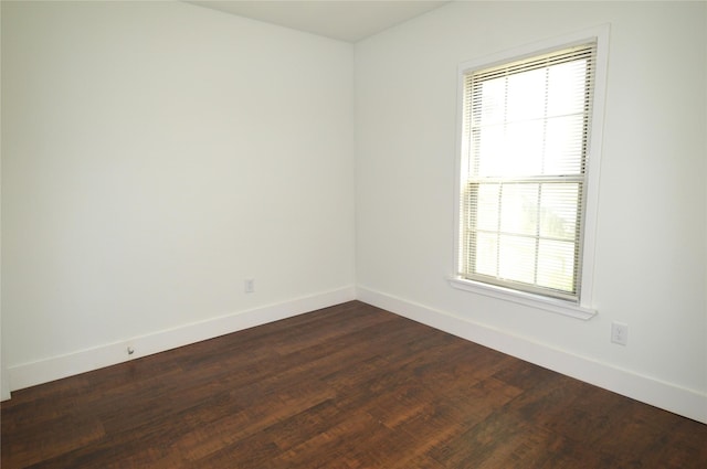 405 W Jack St, Baytown, TX 77520 - unfurnished room featuring healthy amount of natural light, baseboards, and dark wood finished floors