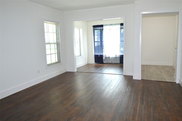 405 W Jack St, Baytown, TX 77520 - empty room with healthy amount of natural light, dark wood finished floors, and baseboards