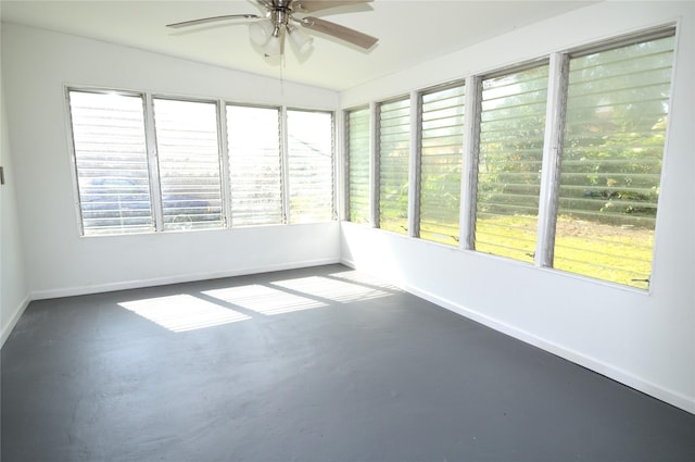 405 W Jack St, Baytown, TX 77520 - unfurnished sunroom featuring baseboards and concrete flooring