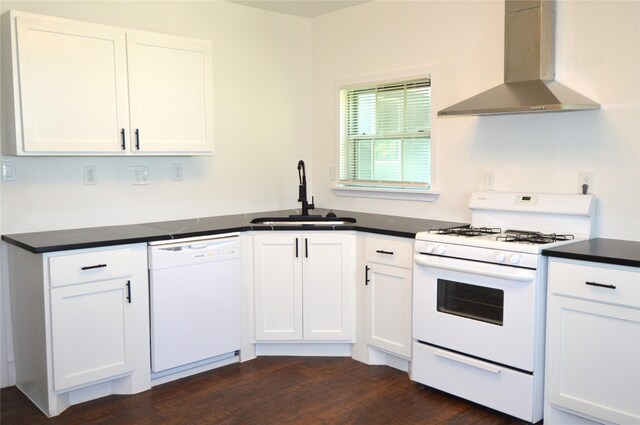 405 W Jack St, Baytown, TX 77520 - kitchen with white appliances, wall chimney range hood, a sink, and dark countertops