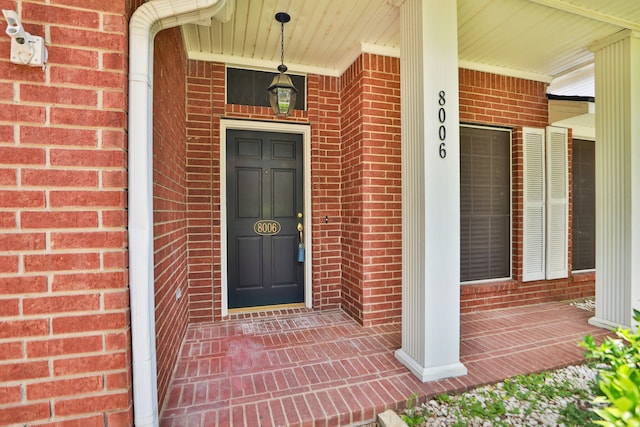 8006 Virginia Water Ln, Houston, TX 77095 - view of exterior entry featuring brick siding and a porch