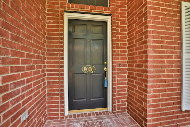 8006 Virginia Water Ln, Houston, TX 77095 - doorway to property featuring brick siding