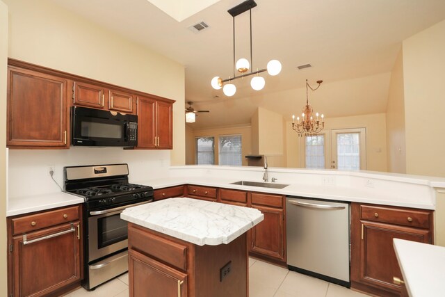 8006 Virginia Water Ln, Houston, TX 77095 - kitchen featuring stainless steel appliances, light tile patterned flooring, a peninsula, light countertops, and a chandelier