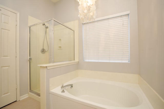 8006 Virginia Water Ln, Houston, TX 77095 - bathroom featuring a bath, a shower stall, and a chandelier