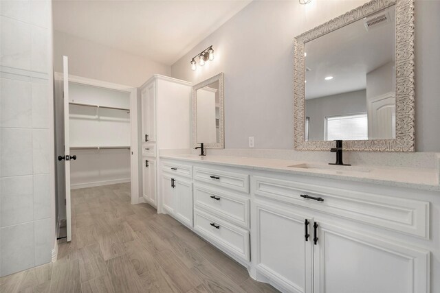 234 Feldspar Ln, Huntsville, TX 77340 - bathroom with double vanity, wood finished floors, and a spacious closet