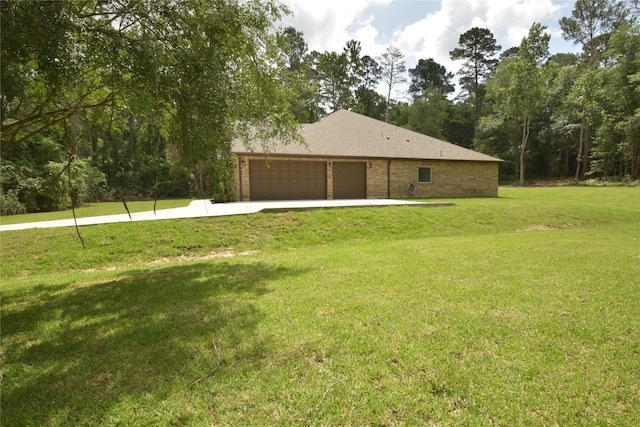 234 Feldspar Ln, Huntsville, TX 77340 - view of home's exterior featuring a lawn, an attached garage, and driveway