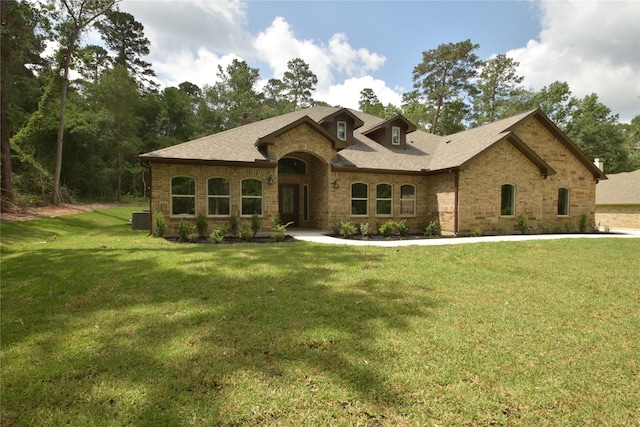 234 Feldspar Ln, Huntsville, TX 77340 - view of front of house featuring brick siding, a front yard, and roof with shingles