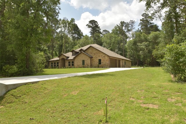 234 Feldspar Ln, Huntsville, TX 77340 - view of front of property featuring a front yard, an attached garage, and driveway
