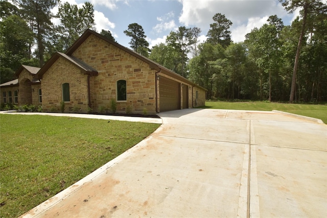 234 Feldspar Ln, Huntsville, TX 77340 - view of front of home featuring a front lawn, stone siding, concrete driveway, and a garage
