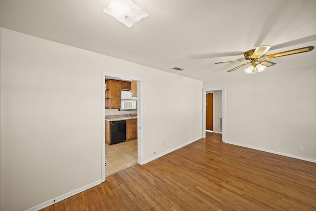 5814 Darnell St, Houston, TX 77074 - unfurnished room featuring ceiling fan, light wood finished floors, baseboards, and a sink