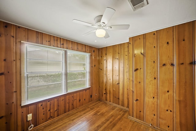 5814 Darnell St, Houston, TX 77074 - spare room featuring wood finished floors, wooden walls, ceiling fan, and baseboards