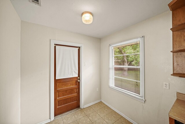 5814 Darnell St, Houston, TX 77074 - doorway to outside featuring baseboards
