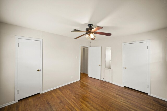 5814 Darnell St, Houston, TX 77074 - unfurnished bedroom featuring wood finished floors, ceiling fan, baseboards, and two closets