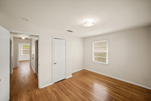 5814 Darnell St, Houston, TX 77074 - unfurnished bedroom with wood finished floors, baseboards, and attic access
