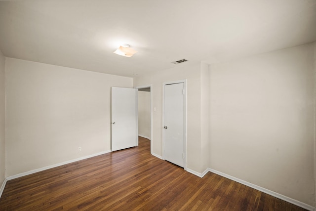 5814 Darnell St, Houston, TX 77074 - unfurnished bedroom featuring dark wood-style floors, baseboards, and a closet