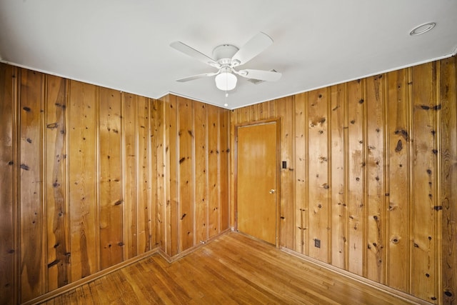 5814 Darnell St, Houston, TX 77074 - empty room featuring wood finished floors, wood walls, and ceiling fan