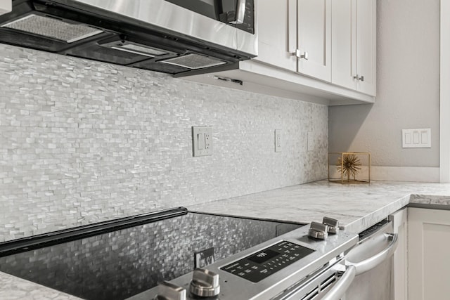820 Threadneedle St Unit 248, Houston, TX 77079 - kitchen with appliances with stainless steel finishes, tasteful backsplash, white cabinets, and light stone counters