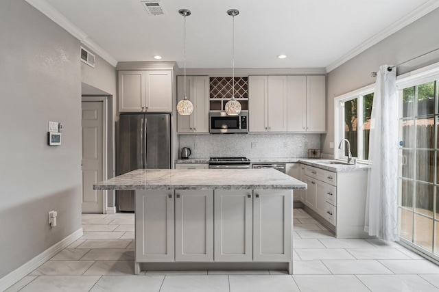820 Threadneedle St Unit 248, Houston, TX 77079 - kitchen with stainless steel appliances, crown molding, a center island, gray cabinets, and tasteful backsplash