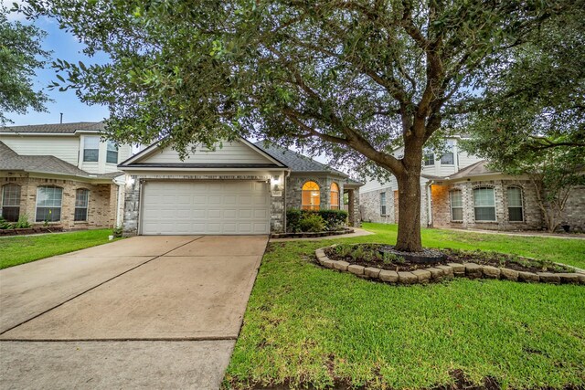 18423 Grove Brook Ln, Cypress, TX 77429 - view of front of property featuring a garage, a front lawn, and driveway