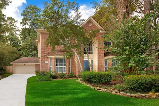 23 Shellbark, The Woodlands, TX 77382 - view of front of house featuring concrete driveway, brick siding, a front lawn, and a garage