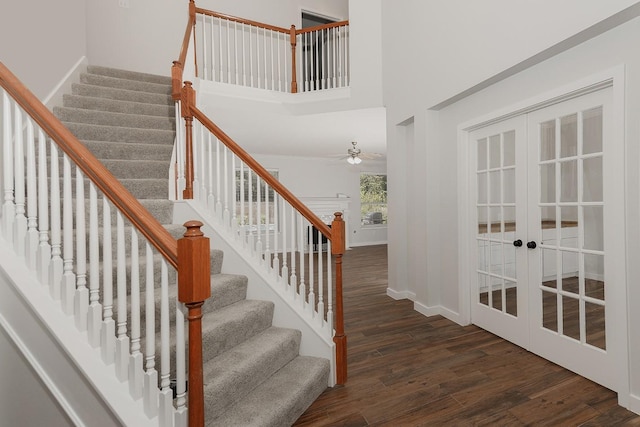 23 Shellbark, The Woodlands, TX 77382 - stairs featuring wood finished floors, french doors, baseboards, a ceiling fan, and a high ceiling