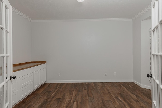 23 Shellbark, The Woodlands, TX 77382 - empty room featuring ornamental molding, dark wood-style flooring, and baseboards