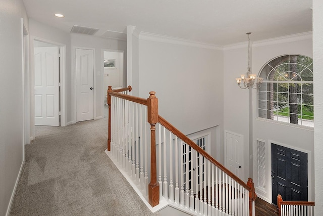 23 Shellbark, The Woodlands, TX 77382 - hallway featuring an upstairs landing, a chandelier, baseboards, crown molding, and carpet floors