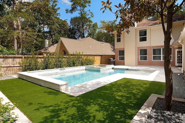 23 Shellbark, The Woodlands, TX 77382 - view of swimming pool featuring a patio area, a pool with connected hot tub, and area for grilling