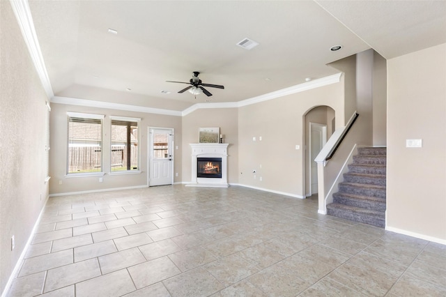 13303 Canton Cliff Ct, Humble, TX 77346 - unfurnished living room featuring a ceiling fan, ornamental molding, stairway, baseboards, and a glass covered fireplace