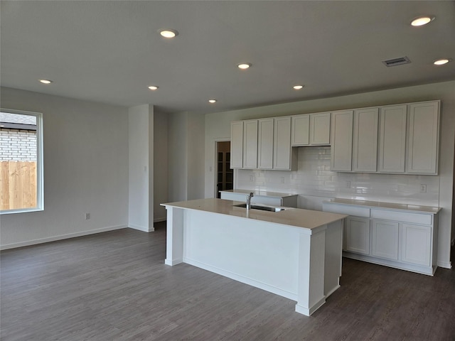 3068 Ruby Ridge Dr, Katy, TX 77493 - kitchen featuring a sink, backsplash, dark wood-style flooring, an island with sink, and recessed lighting