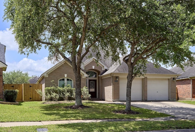 13012 Balsam Breeze Ln, Pearland, TX 77584 - view of front of house featuring a garage, brick siding, concrete driveway, and roof with shingles